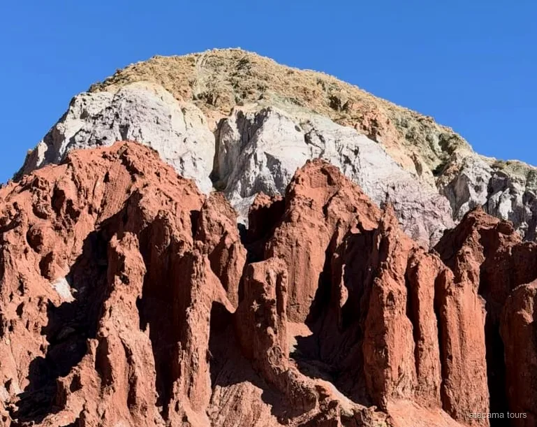 Rainbow Valley tour, layered red and green rock formations at Valle del Arcoiris